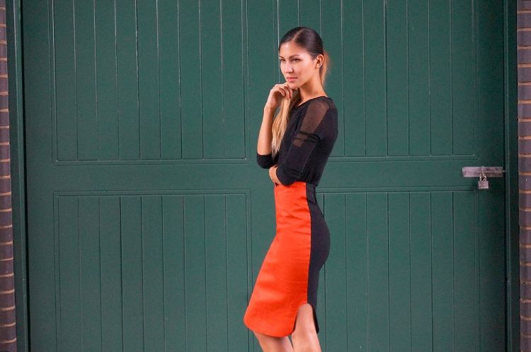 Euriental - London fashion blogger, wearing sheer panelled black top and black and red asymmetrical skirt.