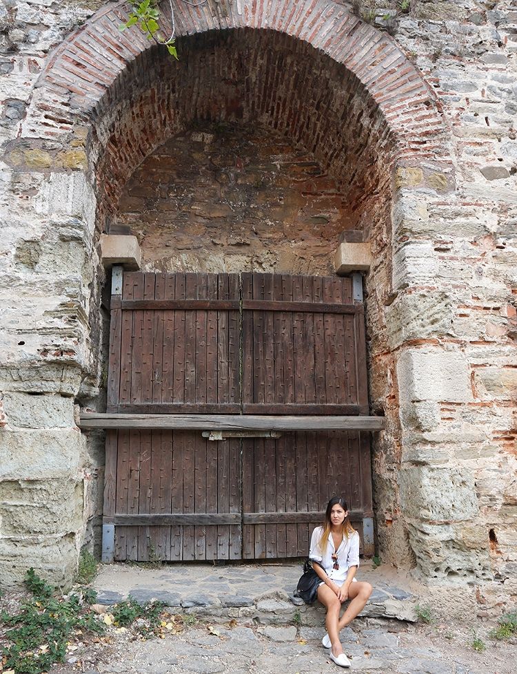 Euriental | Wearing white cotton shirt with pastel green shorts at Rumeli Castle in Istanbul.